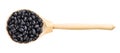 Top view of wood spoon with black mexico beans