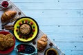 Top view of a wood table full of cakes, fruits, coffee, biscuits Royalty Free Stock Photo