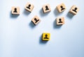 Top view wooden blocks with people icon on blue background.