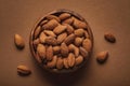 Top view of in wooden bowl almonds