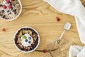 Top view of a wooden breakfast table with two bowls of oatmeal w