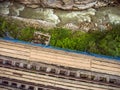 Top view of wooden bridge with narrow gauge railway. Rapids on a fast mountain stream in the rocks Royalty Free Stock Photo