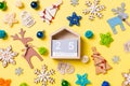 Top view of wooden calendar on yellow background with New Year toys and decorations. The twenty fifth of December. Christmas time Royalty Free Stock Photo
