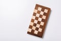 Top view of wooden checkerboard on white background Royalty Free Stock Photo