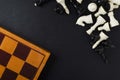 Top view of wooden chess board and pieces on the black background.Empty space