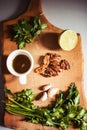 Top view of wooden cutting board with pesto ingredients Royalty Free Stock Photo