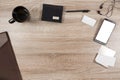 Wooden desk with smartphone, headphones, pen, name tag, wallet, Royalty Free Stock Photo