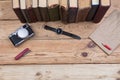 Top view on wooden desktop with books, watch and camera