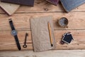 Top view on wooden desktop with books, watch and copy space for