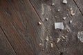 Top view on wooden floor being half covered with trash and dust