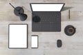 Top view of wooden office desk top with laptop, smartphone and cellphone, coffee cup and supplies. Mock up Royalty Free Stock Photo