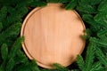 Top view of wooden plate decorated with fir tree branches. New Year dinner concept with empty space for your design Royalty Free Stock Photo