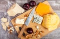 On top view of wooden plate with different tupe of cheese