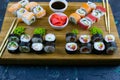 Top view of wooden platter with great set of delicious Nigiri sushi and Tempura rolls with Maki and Uramaki rolls Royalty Free Stock Photo