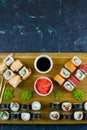 Top view of wooden platter with great set of delicious Nigiri sushi and Tempura rolls with Maki and Uramaki rolls Royalty Free Stock Photo