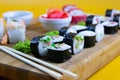 Top view of wooden platter with great set of delicious Nigiri sushi and Tempura rolls with Maki and Uramaki rolls Royalty Free Stock Photo