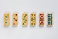 Top view of wooden six dominoes gaming pieces with double spots on it on the white background