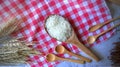 Top View Wooden Spoon With Rice on Table Cloths Background,