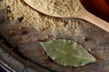 Top view of a wooden spoons full of curry on wooden barrel background, selective focus. Royalty Free Stock Photo