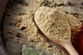 Top view of a wooden spoons full of paprica and black pepper on wooden barrel background, selective focus. Royalty Free Stock Photo