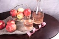 Top view of a wooden table with a glass of apple cider vinegar with a measuring tape and apples. Royalty Free Stock Photo