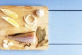 Top view on wooden table with ingredients for cooking. Vegetables and fish on cutting board. Healthy food concept. Top view with c Royalty Free Stock Photo