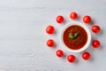 Top view of wooden table with plate with gazpacho and tomato cherry Royalty Free Stock Photo