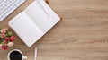 Top view wooden workspace office desk with computer and office supplies. Flat lay work table with blank notebook, keyboard, flower Royalty Free Stock Photo