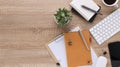 Top view wooden workspace office desk with computer and office supplies. Flat lay work table with blank notebook, keyboard, green Royalty Free Stock Photo