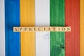 Top view of the word Appreciation spelled on wooden cubes