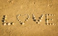 Top view of word love written with seashells on sand Royalty Free Stock Photo