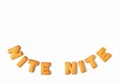 Top view of the word NITE NITE, made with alphabet shaped biscuits on white background, with free space for design