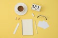 Top view of work place with coffee cup, notebook, ruler, eraser, pencil, glasses on yellow background. working place concept Royalty Free Stock Photo