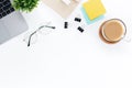 Top view of Work space desk with a laptop, notebook, coffee cup, post-it on a white table with copy space Royalty Free Stock Photo