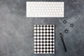 Top view of work space office desk black background with paper notebook copybook, keyboard, pen and clips. Copy space Royalty Free Stock Photo