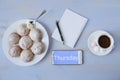 Top view of work space with phone and inscription with cup of coffee, cookies and notebook with copy space