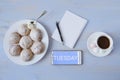 Top view of work space with phone and inscription with cup of coffee, cookies and notebook with copy space Royalty Free Stock Photo