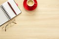 Top view on work table. Coffee cup, glasses, notes Royalty Free Stock Photo