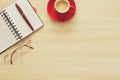 Top view on work table. Coffee cup, tablet, glasses, notes and pen Royalty Free Stock Photo