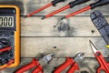 Top view of work tools for residential electrical installation on antique wooden background.