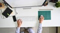 Top view worker working on workspace, Man using computer above shot. Royalty Free Stock Photo