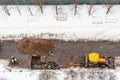 Top view of workers and excavator digging road Royalty Free Stock Photo