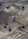 Top view of workers repairing underground heating mains through open hatches Royalty Free Stock Photo