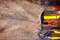Top view of Working construction tools,wrench,hammer,screwdriver,plier,electric drill,tape measure,machinist square on wooden