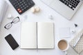 Top view of a working desk with open blank notebook Royalty Free Stock Photo