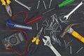 Top view on working hand tools,wrench, screwdriver, pliers, hammer, adjustable spanner, office knife, scattered nails and screws. Royalty Free Stock Photo