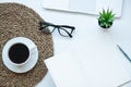 Top view working space with laptop, plant, cup of coffee , notebook, pen and glasses Royalty Free Stock Photo