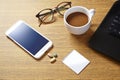 Top view of working table with cup of coffee ,medicine and laptop computer. Royalty Free Stock Photo