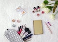 Top view, workspace, bag for cosmetic brushes, makeup and flowers Royalty Free Stock Photo