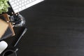 Top view workspace with book and pen coffee cup, computer keyboard with book on black office desk work wooden texture. Royalty Free Stock Photo